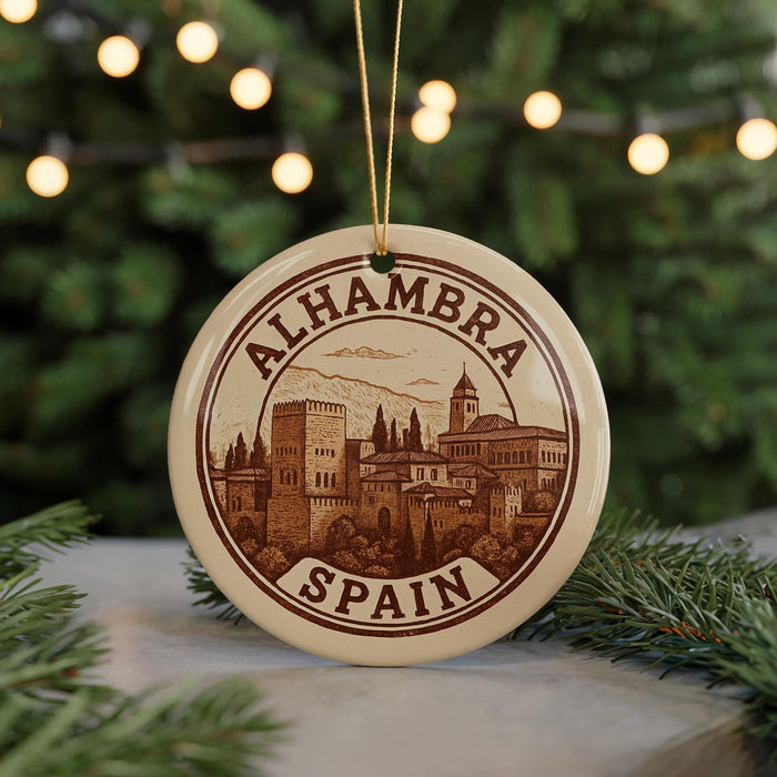 A circular ornament with the text "ALHAMBRA SPAIN" printed on it, featuring an illustration of a cityscape.