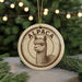 A circular ornament featuring an illustration of an alpaca, with the word "ALPACA" written around the edge.