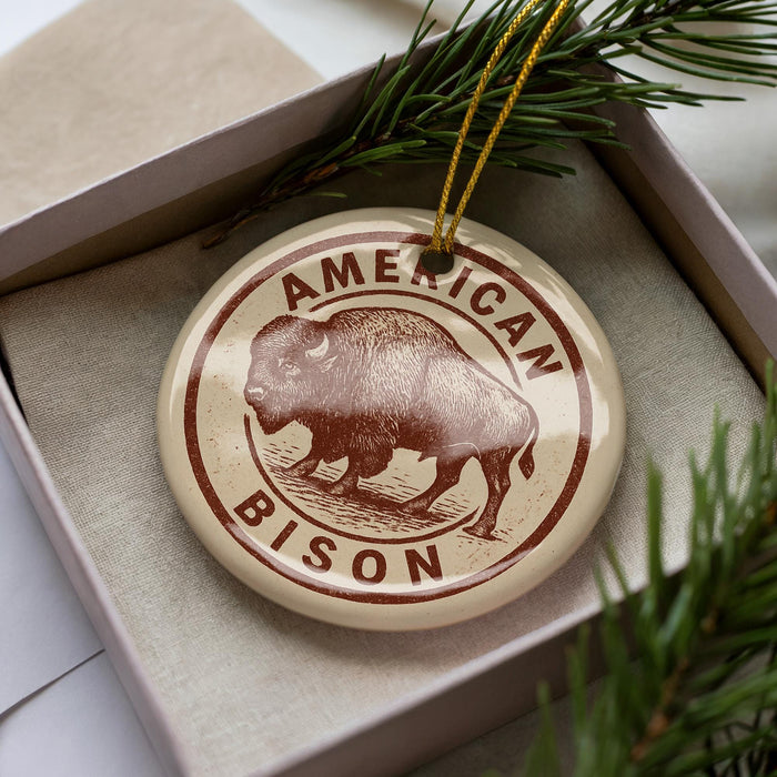 A circular ornament with the text "AMERICAN BISON" printed on it, featuring an illustration of a bison.