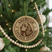 A Christmas tree decorated with ornaments, including a circular ornament with a Cocker Spaniel image and the text "AMERICAN COCKER SPANIEL".