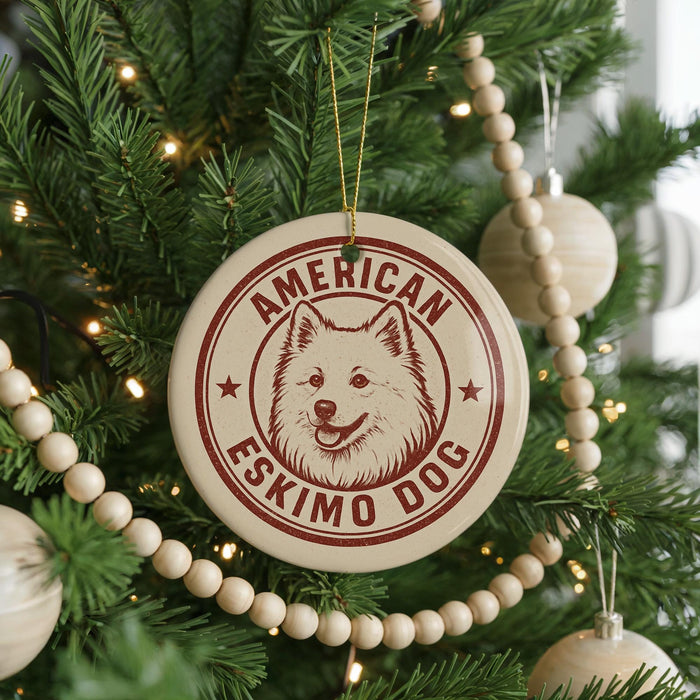 A Christmas tree decorated with ornaments, including a circular ornament with a dog's face and the text "AMERICAN ESKIMO DOG" printed on it.