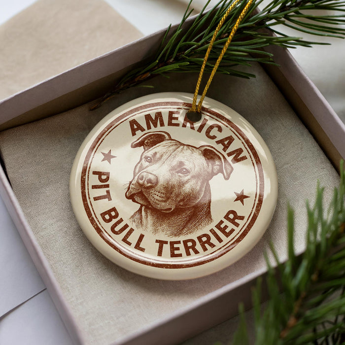 A circular ornament with a picture of a pit bull terrier dog and the text "AMERICAN PIT BULL TERRIER" printed on it.