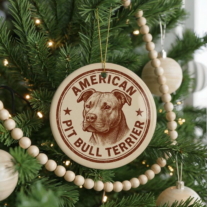 A Christmas tree decorated with ornaments, including a circular ornament with a picture of a pit bull terrier and the text "AMERICAN PIT BULL TERRIER".