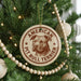 A Christmas tree decorated with ornaments, including a circular ornament with a picture of a pit bull terrier and the text "AMERICAN PIT BULL TERRIER".