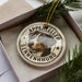 A circular ornament featuring a close-up image of a dog's face, with the text "APENNZELER SENNENHUND" around the edge.