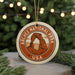 A circular ornament with the text "ARCHES NATIONAL PARK USA" and an illustration of a rock formation, hanging from a string.