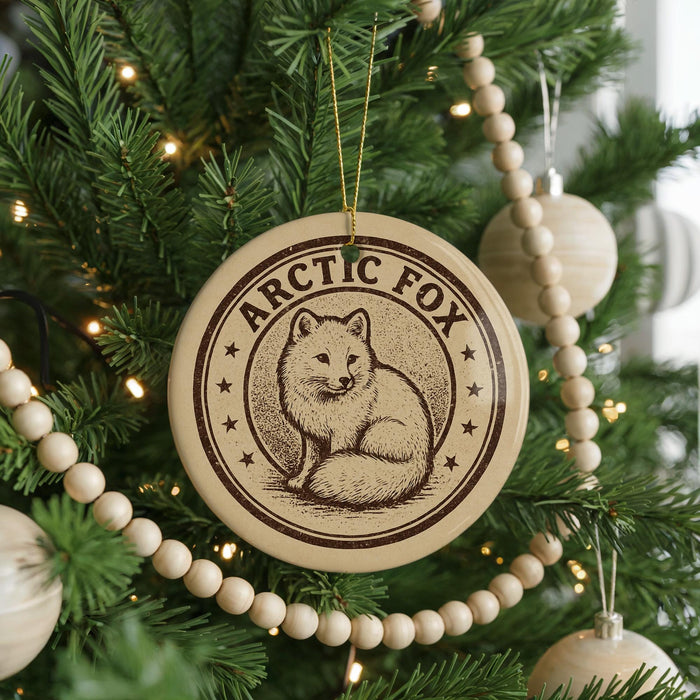 A Christmas tree decorated with ornaments, including a circular ornament with a fox illustration and the text "ARCTIC FOX".