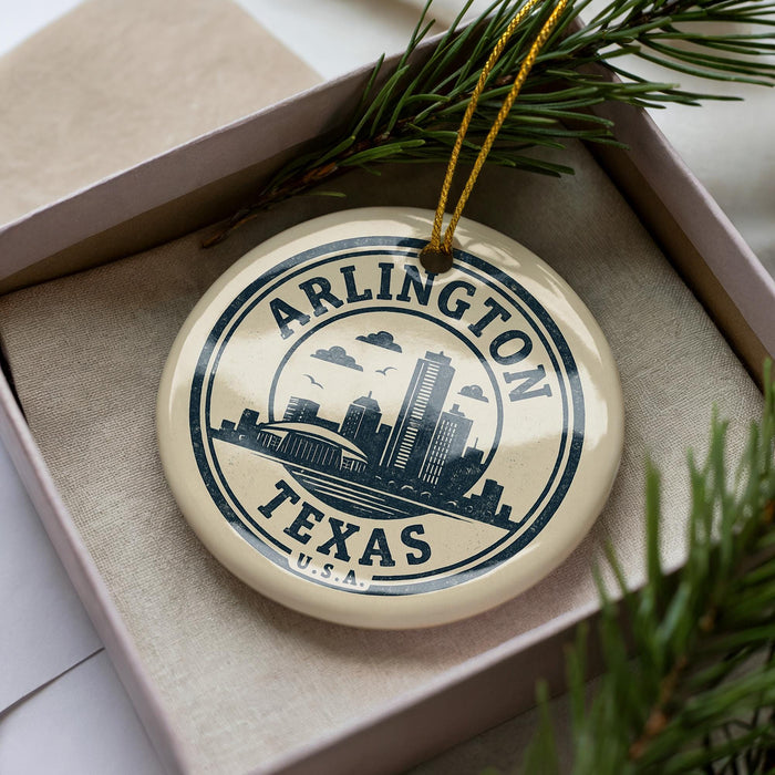 A circular ornament with the text "ARLINGTON TEXAS U.S.A." printed on it, surrounded by pine branches.