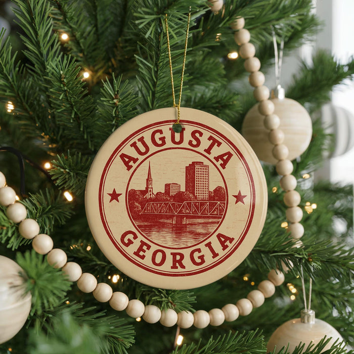 A Christmas tree decorated with ornaments, including a circular ornament with the text "AUGUSTA GEORGIA" and a wooden bead decoration.