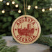 A circular ornament with the text "AUGUSTA GEORGIA" printed on it, hanging from a string.