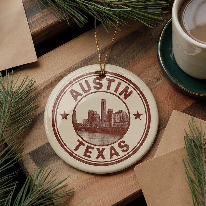 A circular ornament with the text "AUSTIN TEXAS" and a cityscape illustration, hanging on a wooden surface.