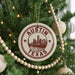 A Christmas tree decorated with ornaments, including a circular ornament with the text "AUSTIN TEXAS" and a cityscape image.