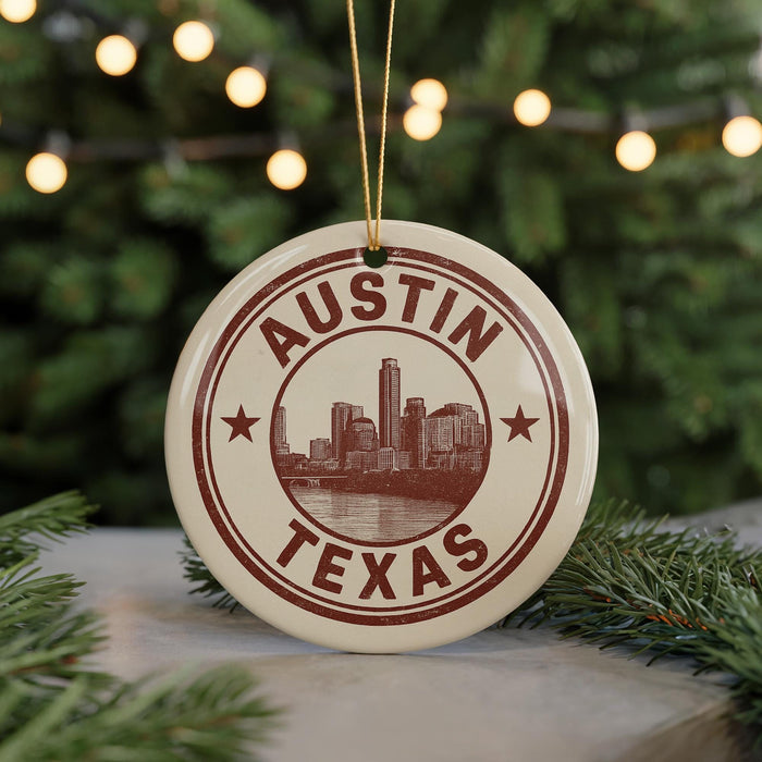 A circular ornament with the text "AUSTIN TEXAS" and an illustration of a city skyline, hanging from a string.