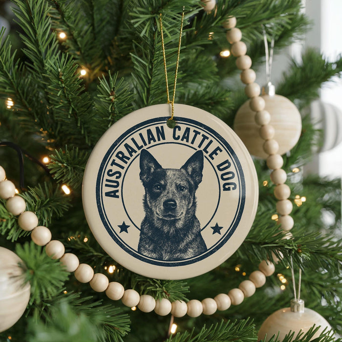 A Christmas tree decorated with ornaments, including a circular ornament with a picture of an Australian Cattle Dog and the text "AUSTRALIAN CATTLE DOG" around the edge.