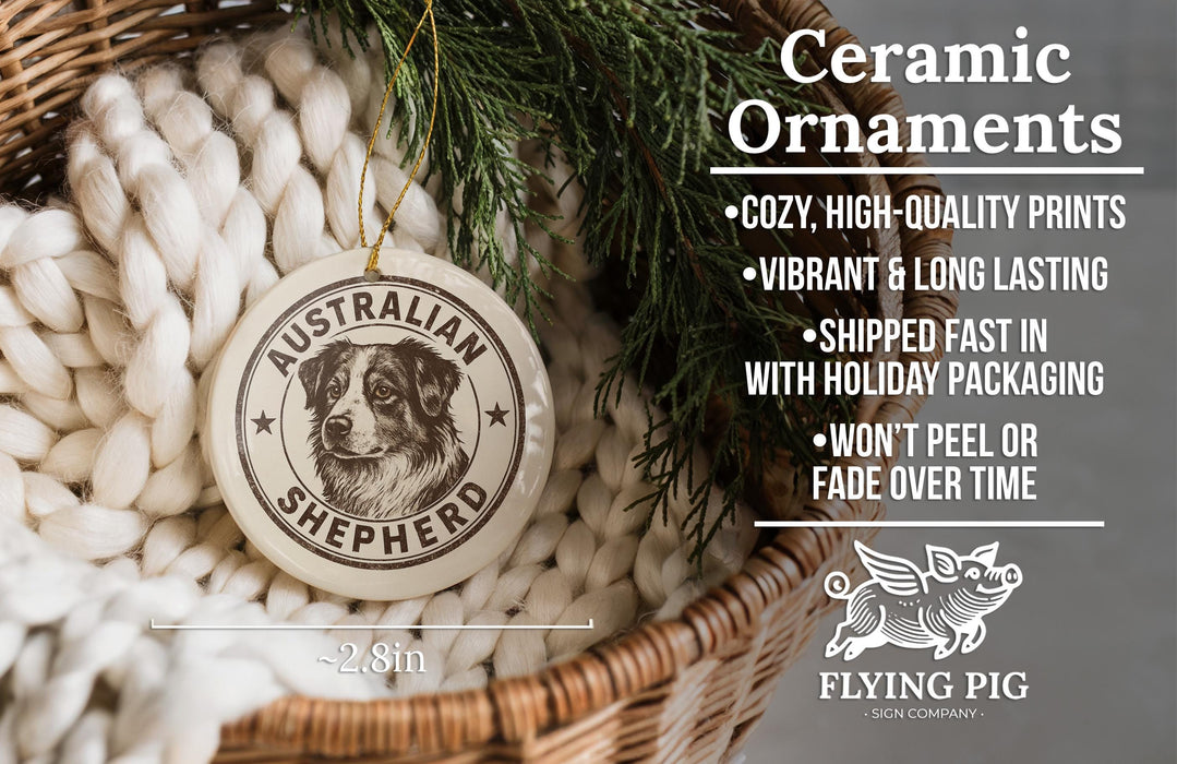 Ceramic ornaments featuring an Australian Shepherd dog, with a wicker basket and greenery in the background.