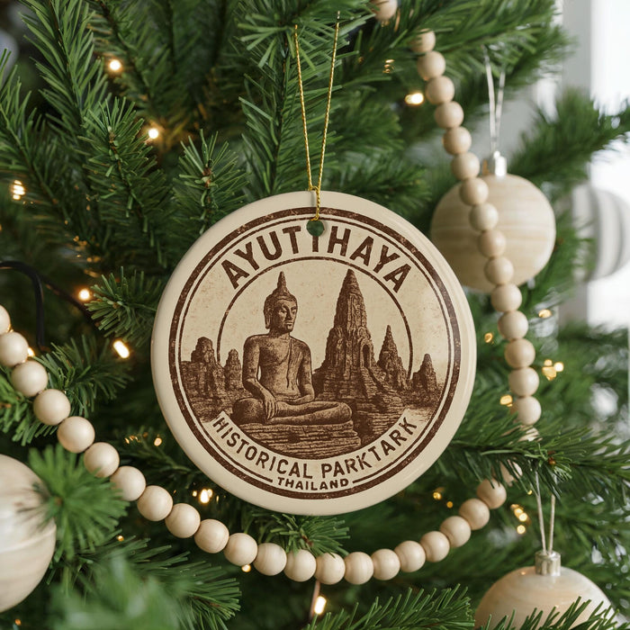 A circular ornament on a Christmas tree, featuring a Buddha statue and the text "AYUTHAYA HISTORICAL PARKTARK THAILAND".