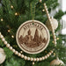 A circular ornament on a Christmas tree, featuring a Buddha statue and the text "AYUTHAYA HISTORICAL PARKTARK THAILAND".