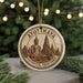 A circular ornament featuring a Buddha statue and the text "AYUTTHAYA HISTORICAL PARKTARK THAILAND" is displayed on a table with pine branches in the background.