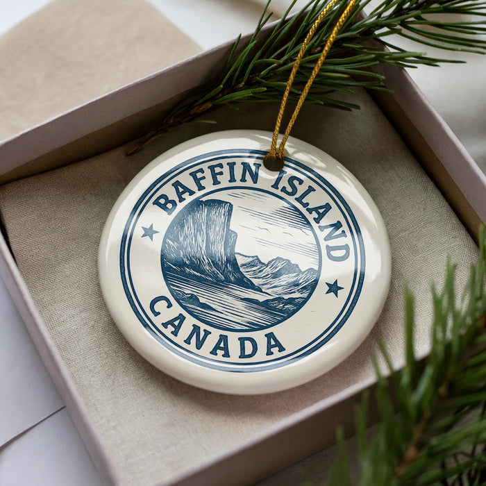 A circular ornament with the text "Baffin Island Canada" printed on it, surrounded by pine branches.
