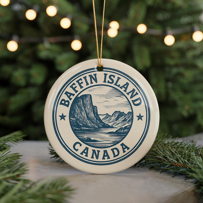 A circular ornament with the text "Baffin Island Canada" and a mountain illustration, hanging from a string.