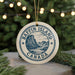 A circular ornament with the text "Baffin Island Canada" and a mountain illustration, hanging from a string.