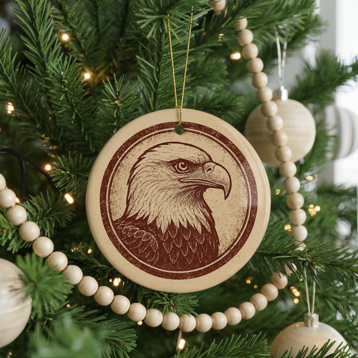 A Christmas tree decorated with ornaments, including a circular ornament featuring a close-up of an eagle's head.