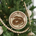 A round ornament on a Christmas tree featuring a snake design, with the text "BALL PYTHON" printed on it.