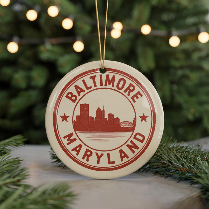A circular ornament with the text "BALTIMORE MARYLAND" and a silhouette of a city skyline, hanging from a string.