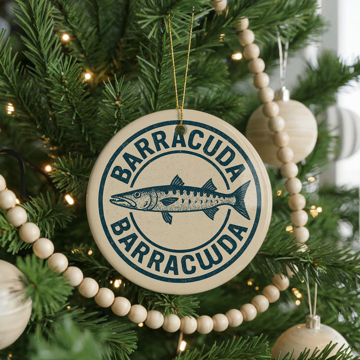 A Christmas tree decorated with ornaments, including a circular ornament with the text "BARRACUDA" and a fish illustration.
