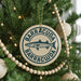 A Christmas tree decorated with ornaments, including a circular ornament with the text "BARRACUDA" and a fish illustration.