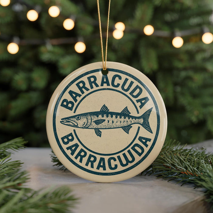 A circular ornament with the text "BARRACUDA" and a graphic of a fish, hanging from a string.