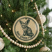 A Christmas tree decorated with ornaments, including a circular ornament with a bat-eared fox illustration and the text "BAT-EARED FOX" printed on it.