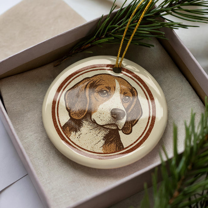 A ceramic ornament featuring a beagle dog is displayed in a box, surrounded by pine branches.
