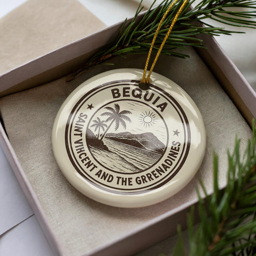 A circular ornament with the text "BEQUIA SAINT VINCENT AND THE GRENADINES" printed on it, surrounded by pine branches.