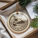 A round ornament with a palm tree and mountain landscape design, featuring the text "BEQUIA SAINT VINCENT AND THE GRENADINES".
