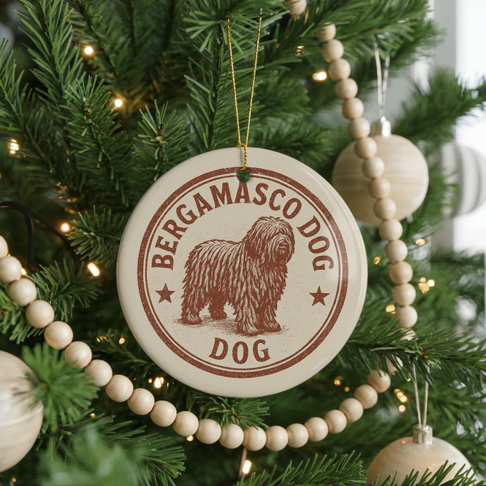 A Christmas tree decorated with ornaments, including a circular ornament with a brown dog image and the text "BERGAMASCO DOG".