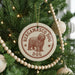 A Christmas tree decorated with ornaments, including a circular ornament with a brown dog image and the text "BERGAMASCO DOG".