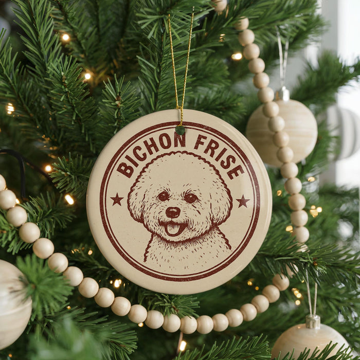 A Christmas tree decorated with ornaments, including a circular ornament with a dog's face and the text "BICHON FRISE" on it.