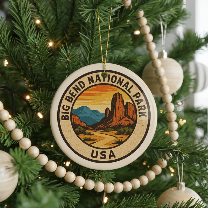 A Christmas tree decorated with ornaments, including a large circular ornament with the text "BIG BEND NATIONAL PARK USA" and a mountain landscape design.