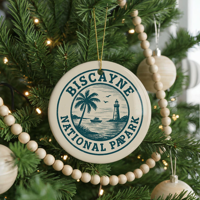 A Christmas tree decorated with ornaments, including a circular ornament with the text "Biscayne National Pap Park" and a lighthouse image.