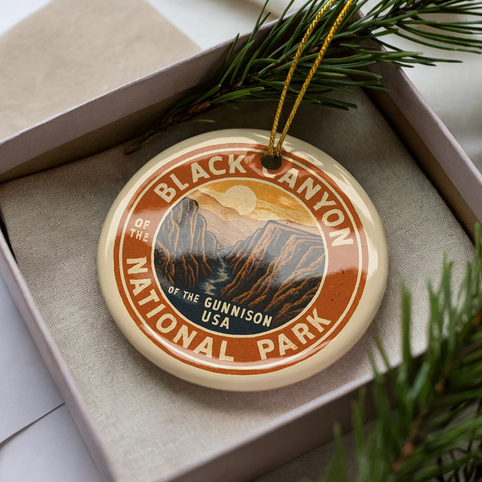 A circular ornament with the text "BLACK CANYON OF THE NATIONAL PARK" and an illustration of a mountain range.