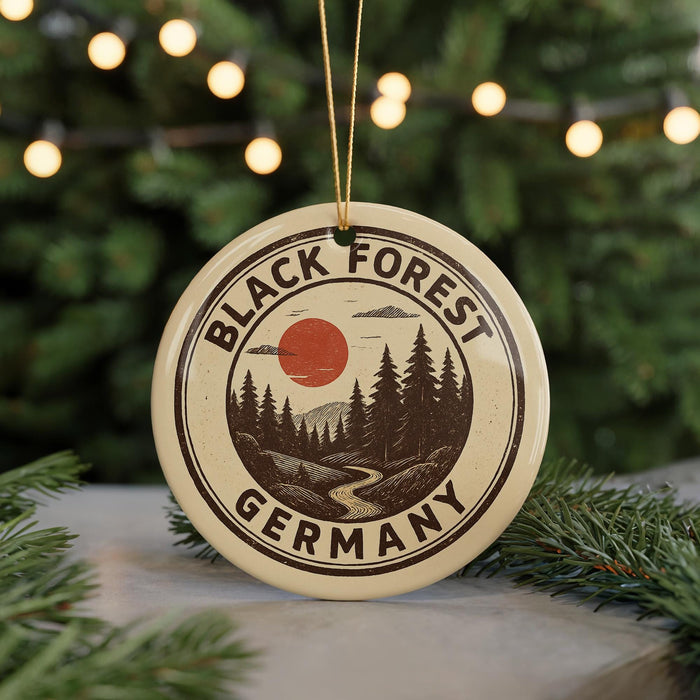 A circular ornament with the text "BLACK FOREST GERMANY" and a landscape illustration, hanging from a string.