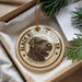 A circular ornament featuring a black and white illustration of a Russian Terrier dog, with the text "BLACK RUSSIAN TERRIER" printed on it.