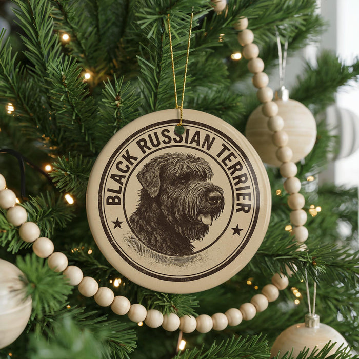 A Christmas tree decorated with ornaments, including a circular ornament with a black and white image of a terrier dog and the text "BLACK RUSSIAN TERRIER".