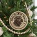 A Christmas tree decorated with ornaments, including a circular ornament with a black and white image of a terrier dog and the text "BLACK RUSSIAN TERRIER".