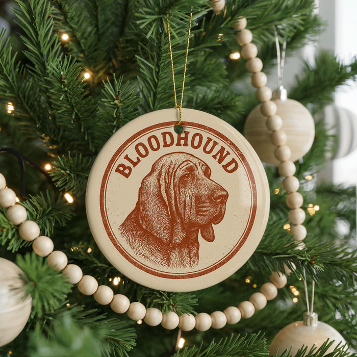 A Christmas tree decorated with ornaments, including a circular ornament with a bloodhound image and the word "BLOODHOUND" written on it.