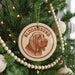 A Christmas tree decorated with ornaments, including a circular ornament with a bloodhound image and the word "BLOODHOUND" written on it.