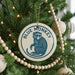 A Christmas tree decorated with ornaments, including a blue and white ornament featuring a monkey.