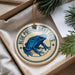 A decorative ornament featuring a blue poison dart frog, with the text "BLUE POISON DART FROG" printed on it.