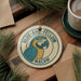 A circular ornament featuring a parrot, with the text "BLUE-AND-YELLOW MACAW" around the edge.